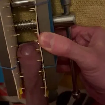Dick caught in a spiked vice | PenisCrush.com